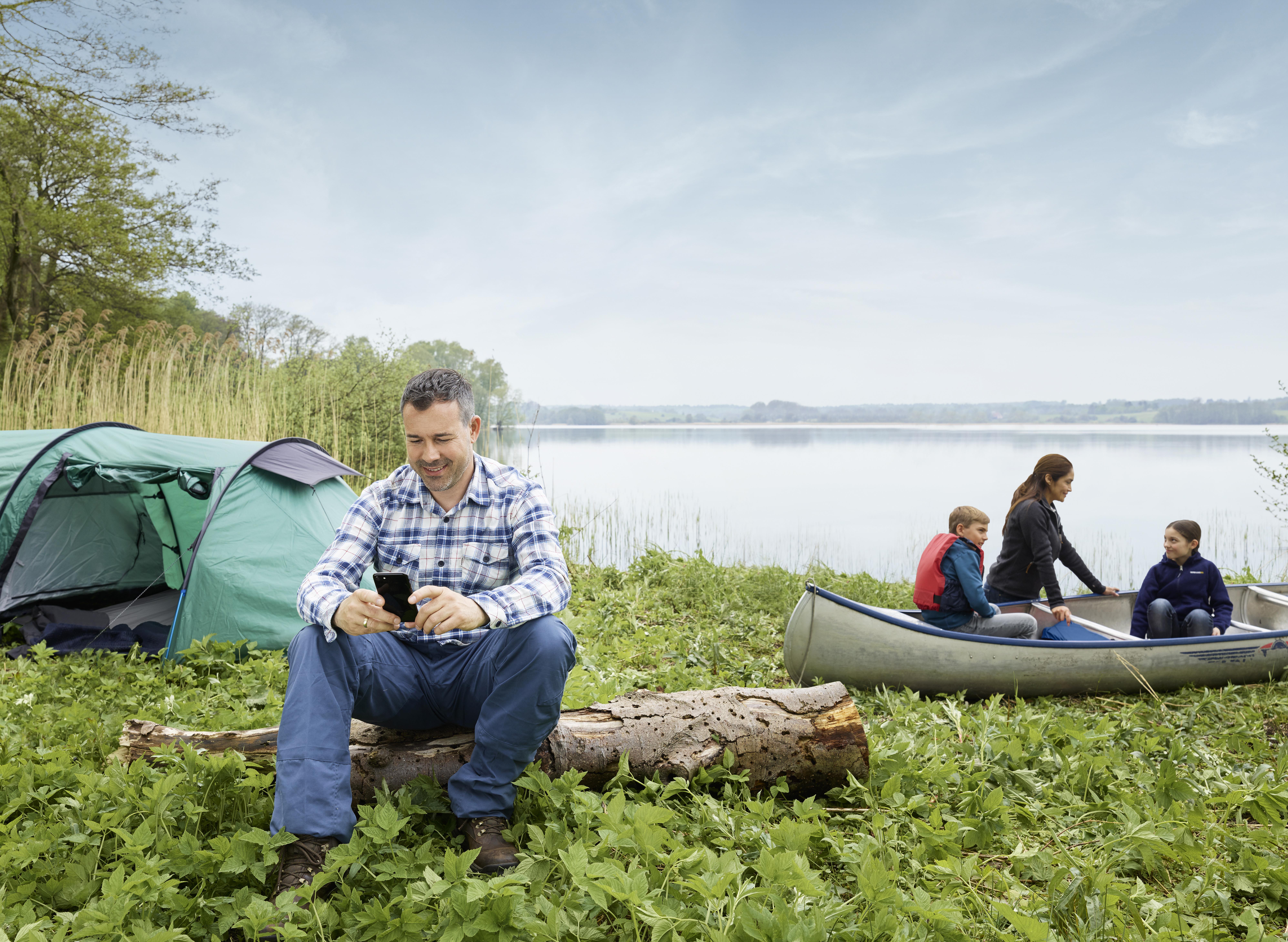 Beltone Boost Max heaing aid user camping with family.
