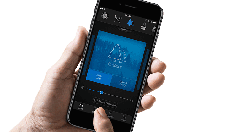 User holding a phone with Beltone apps interface