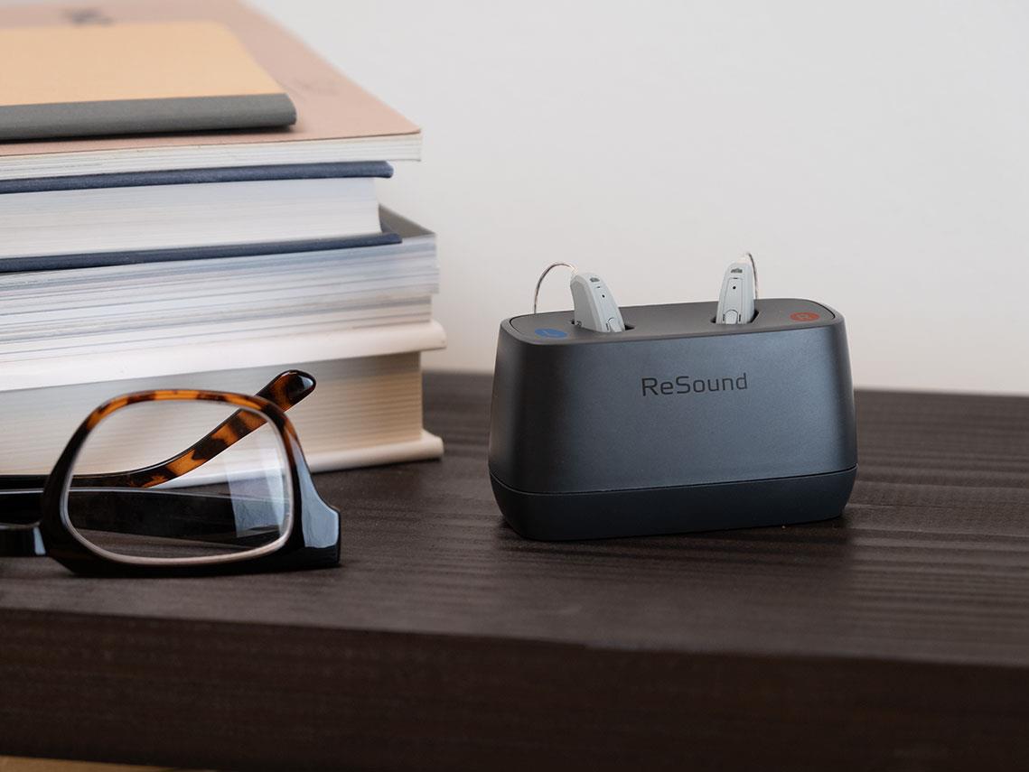 ReSound Key rechargeable RIE hearing aids in a charger