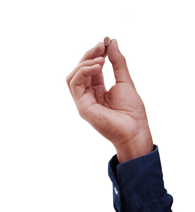 Hand holding ReSound LiNX Quattro CIC custom hearing aid