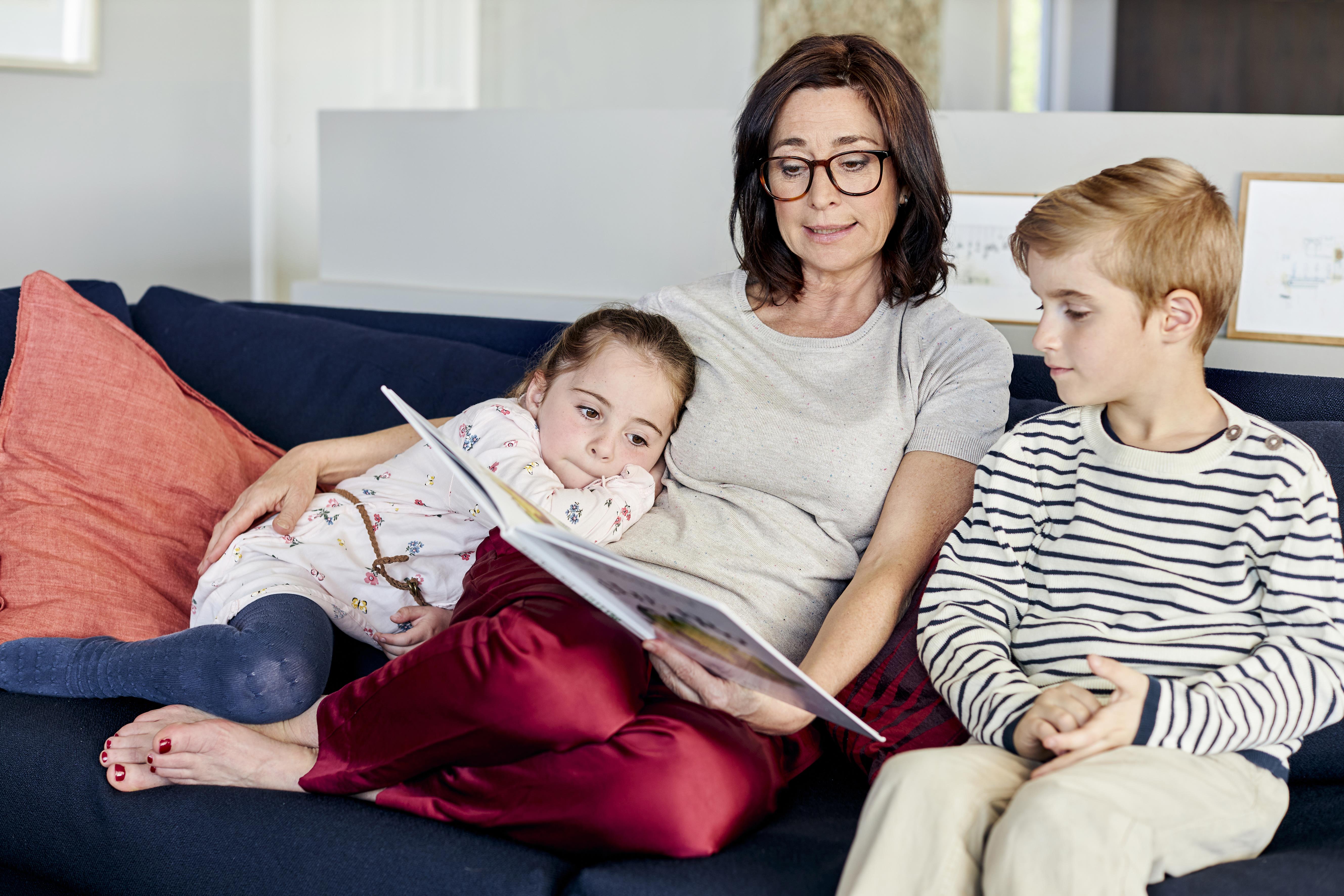 Kvinna som bär ReSound LiNX² hörapparater på restaurang med familjen.