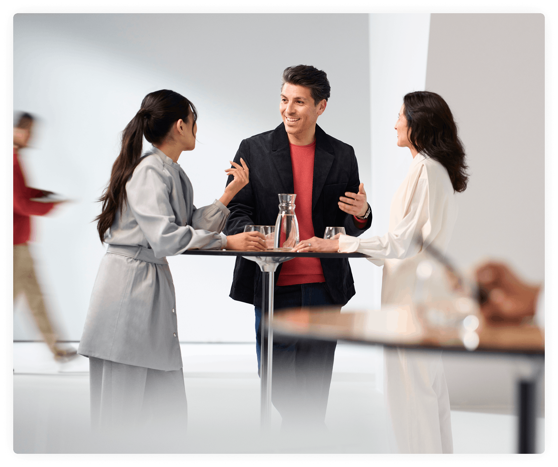People engaged in conversation around a conference table