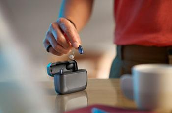 ReSound Vivia hearing aids being put into a charger